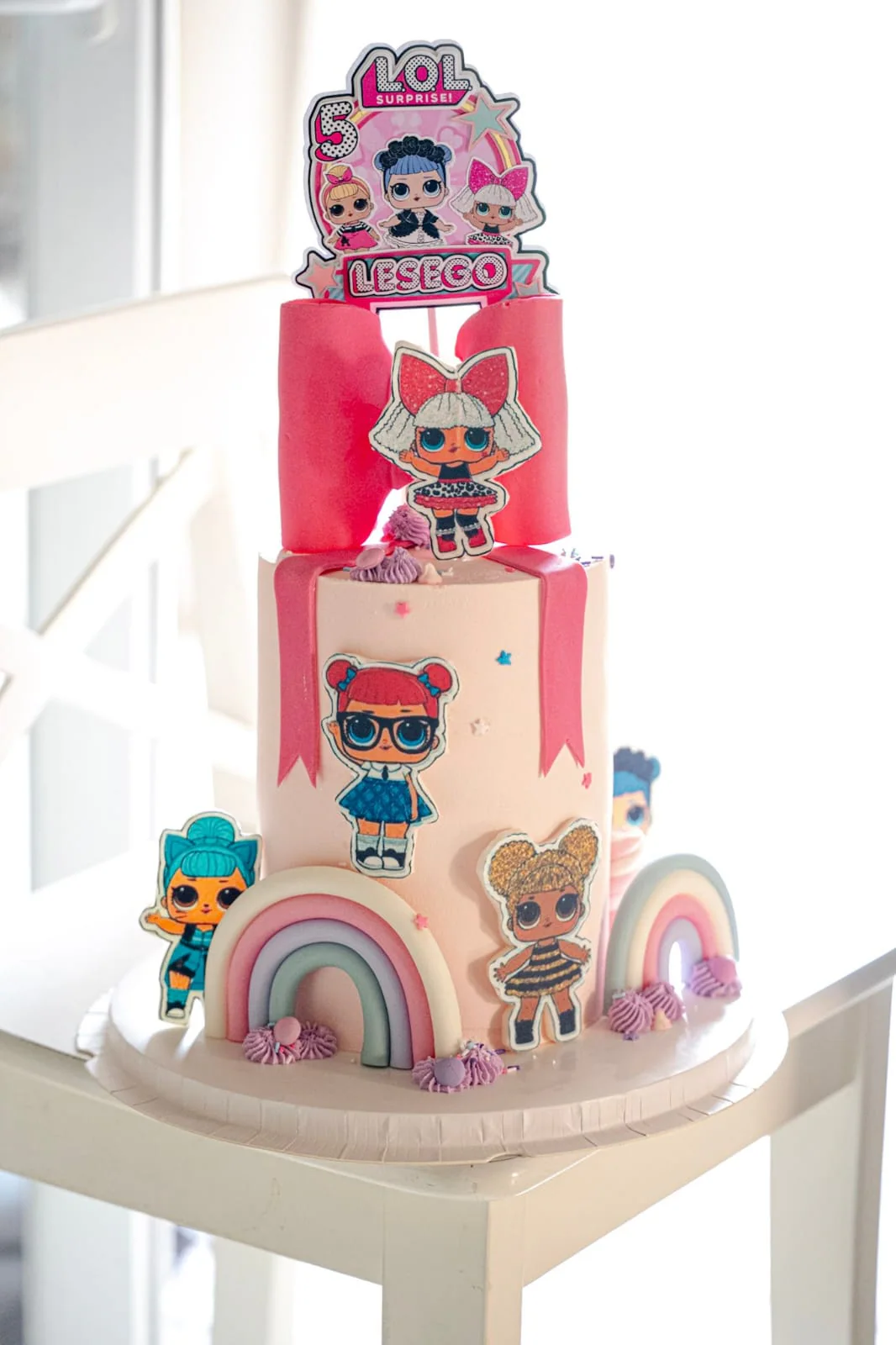 Two-tier pink LOL doll birthday cake