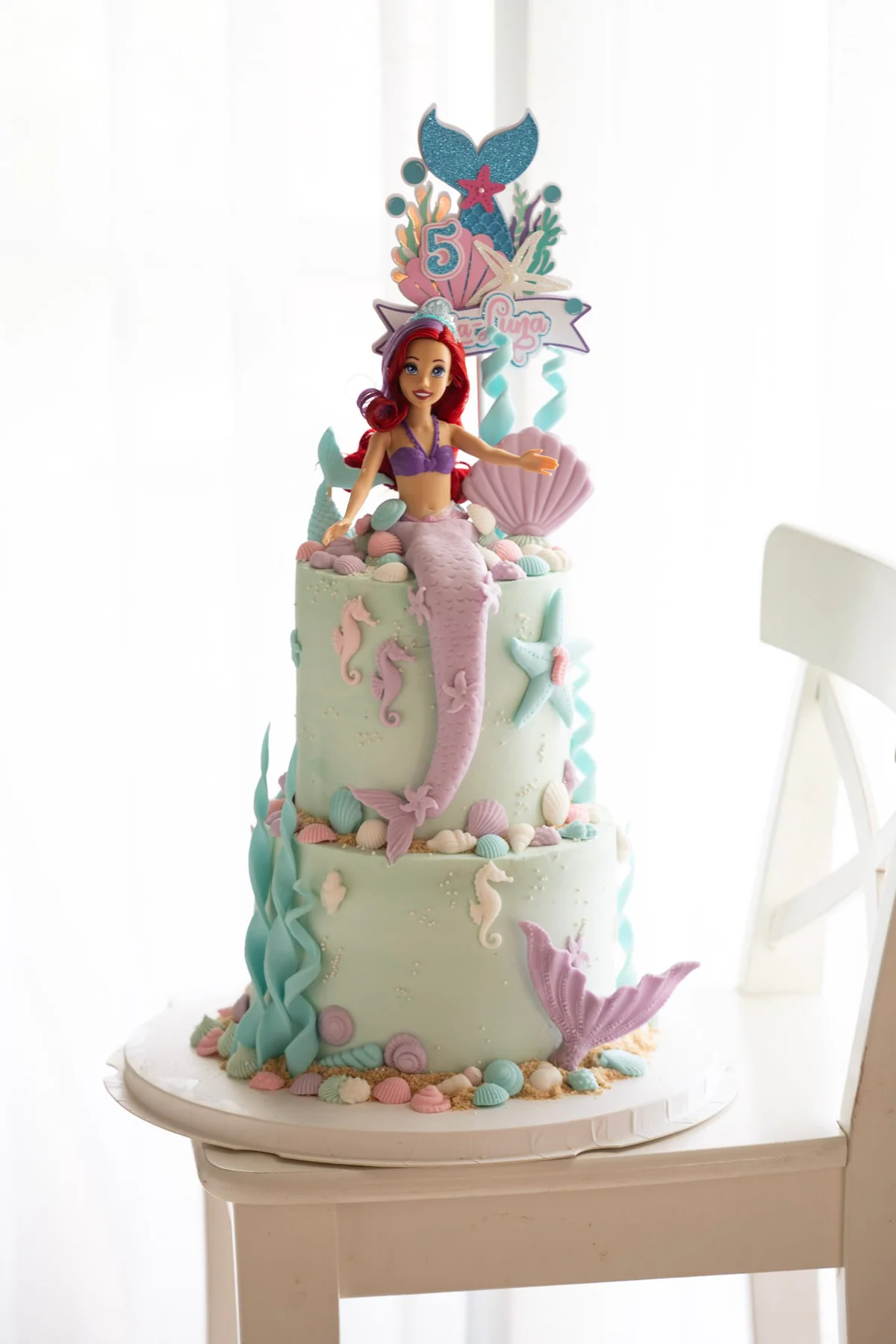 Pastel two-tier mermaid cake with shells and tails
