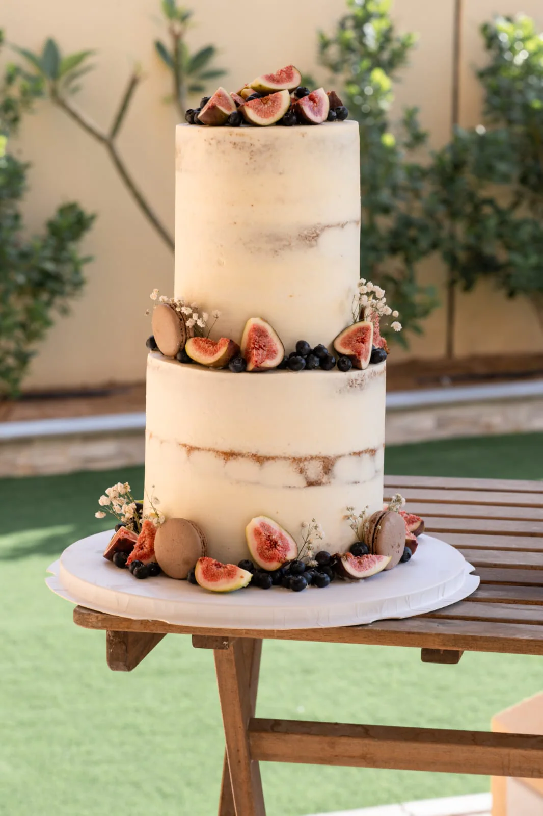 Two-tier semi-naked cake decorated with fresh figs