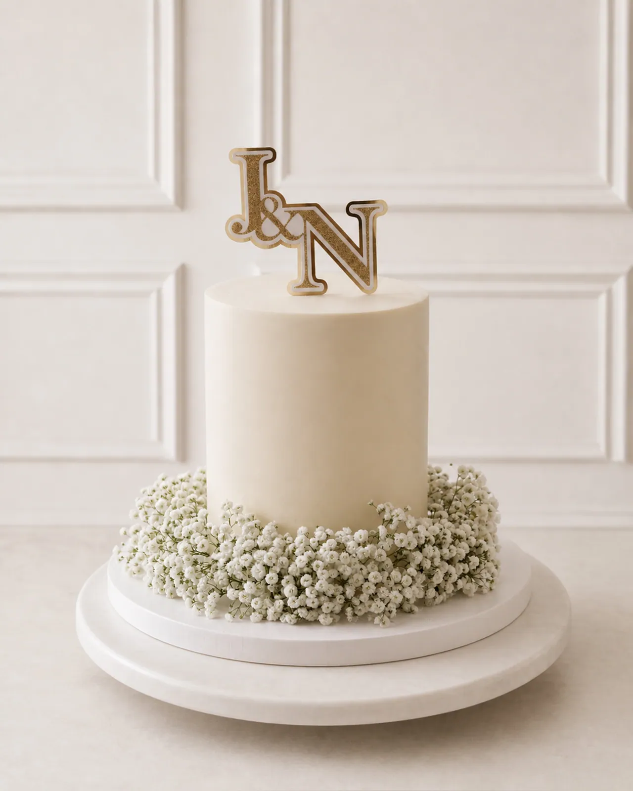 Ivory monogram cake with baby's breath