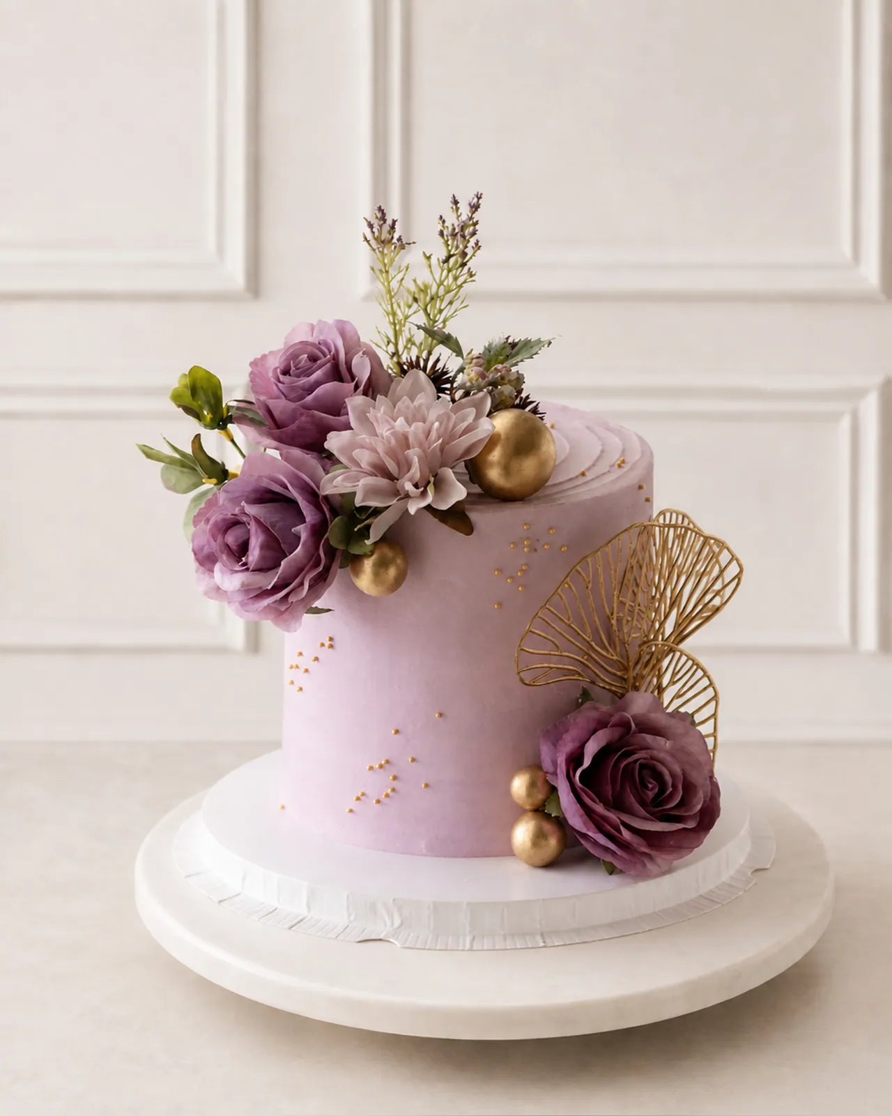 Lilac cake with sugar roses and gold