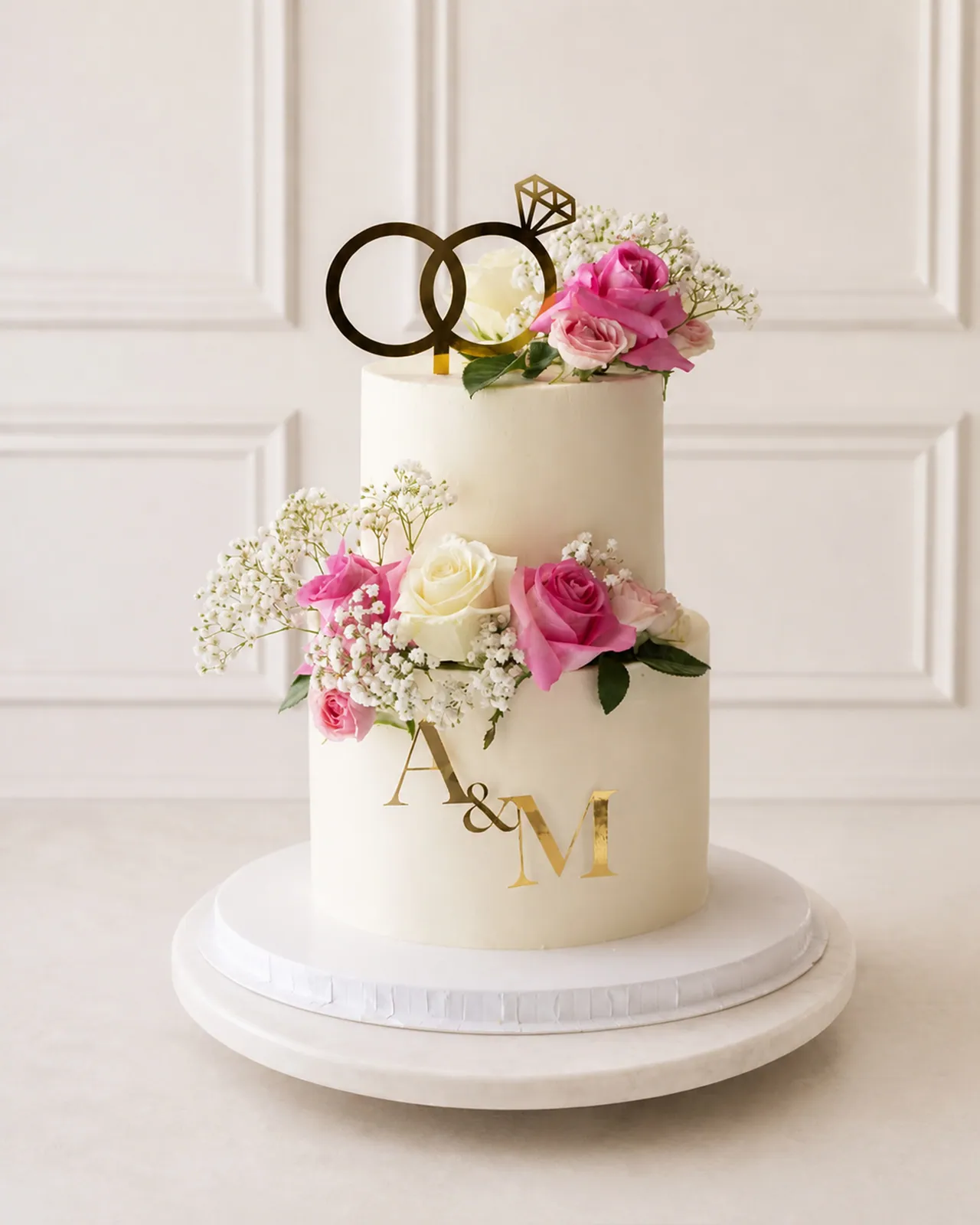 Two-tier engagement cake with rings