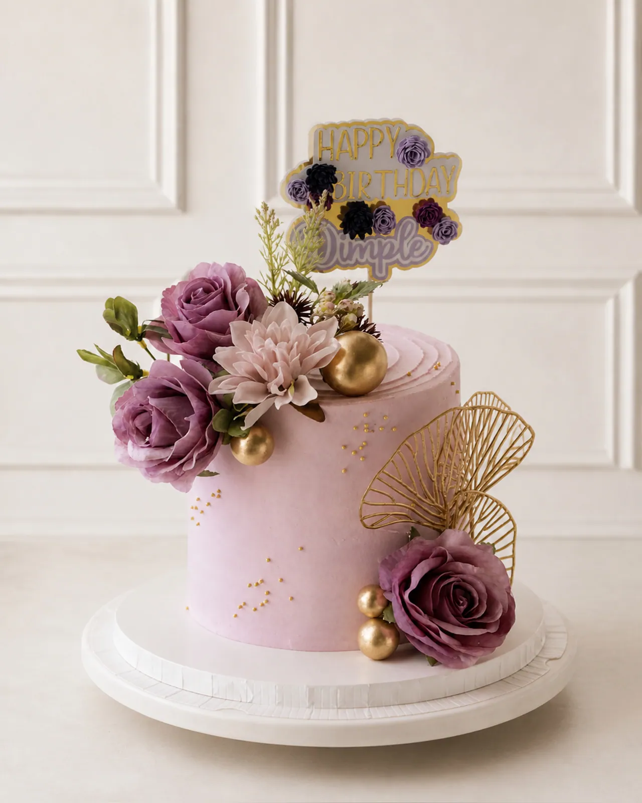 Pink cake with mauve roses and gold