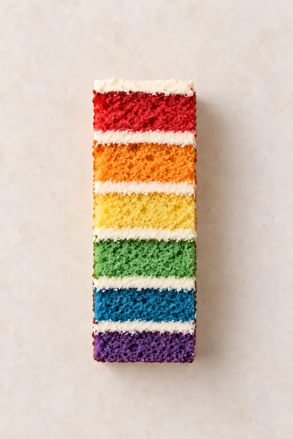 A cut slice of Rainbow Cake
