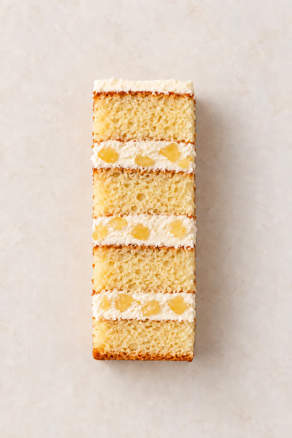 A cut slice of Vanilla Cake with Pineapple