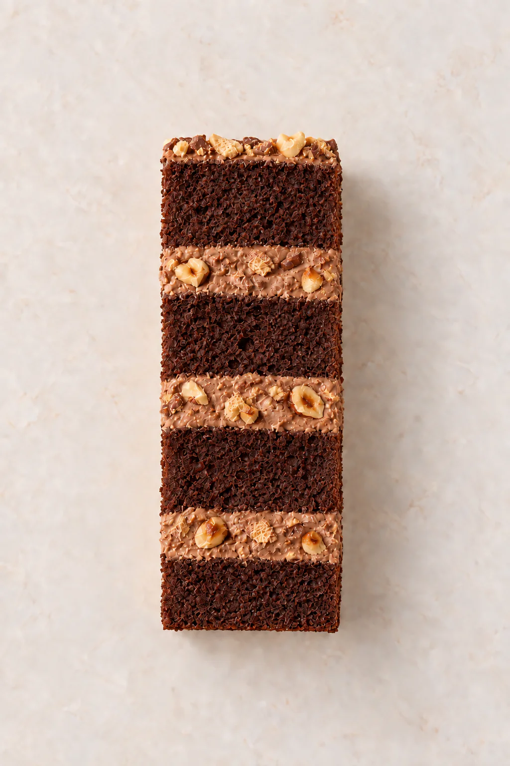 A cut slice of Chocolate Fudge Cake with Ferrero Rocher Mousse Filling